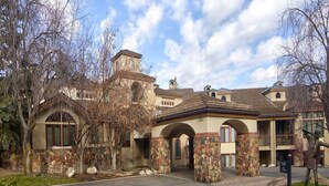 A building with a stone facade, arched windows, and a central tower.