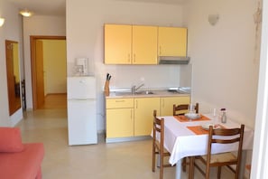 Standard Apartment, 1 Bedroom, Balcony, Sea View | Private kitchen | Full-sized fridge, stovetop, cookware/dishes/utensils, freezer