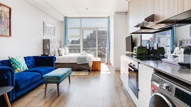 A modern apartment with a living room, bedroom, and kitchen. - Backup-Power Lavish Eclectic City View Apartment on Popular Bree Street (Cape Town)
