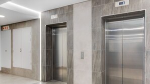 A modern elevator with metallic finish and a digital display. - Backup-Power Lavish Eclectic City View Apartment on Popular Bree Street (Cape Town)