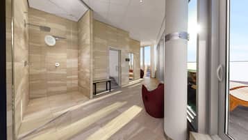 Un hall d’hôtel moderne avec une douche en verre, un banc et un coin salon rouge.
