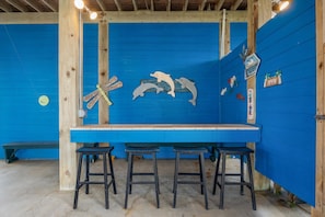 Relax with a drink at the bar, where a long counter and stools await.