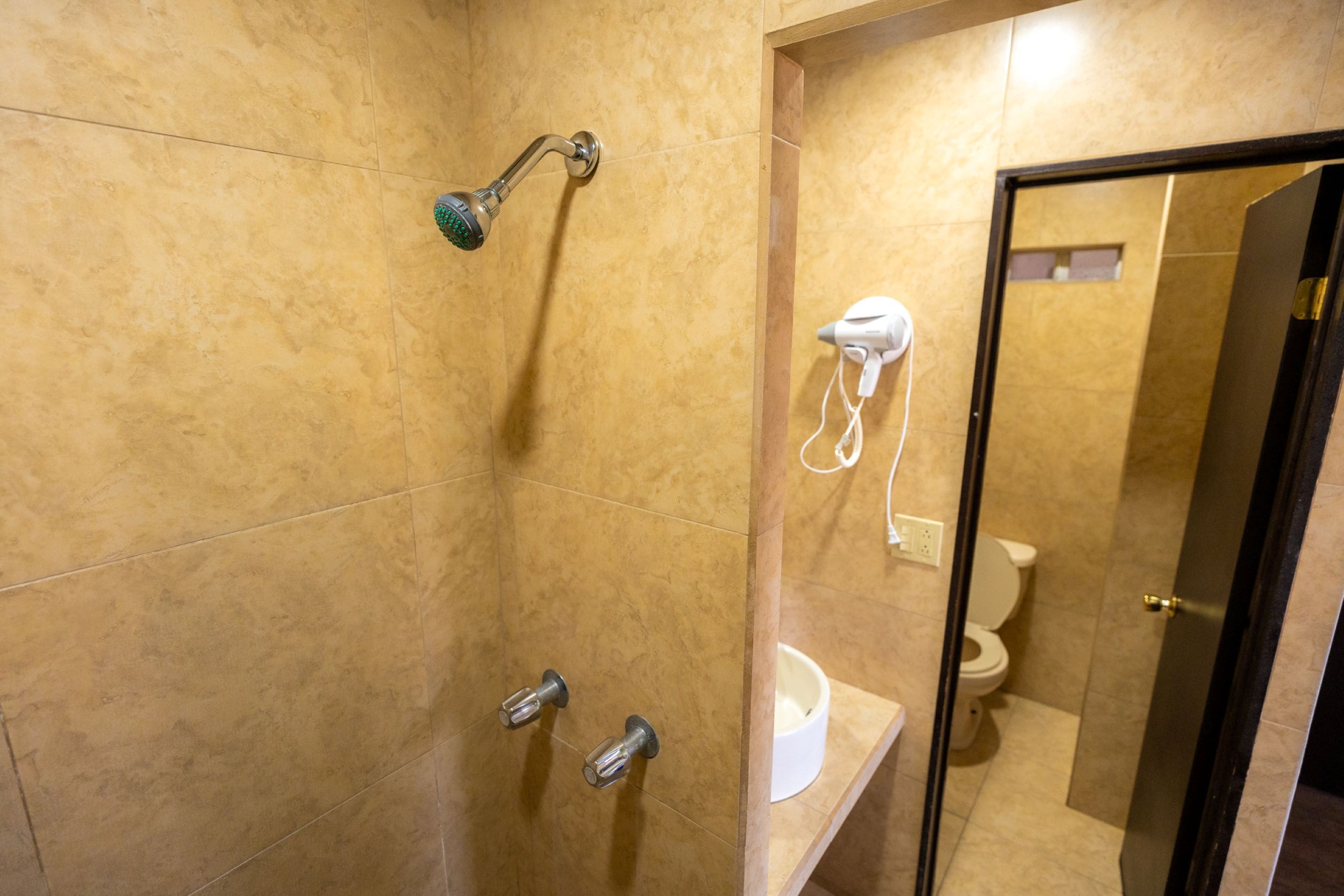 A bathroom with a shower, toilet, and sink.