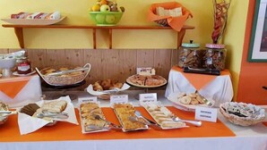 A buffet table with various food items and labels. - La Casita (Antigua)