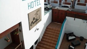 A hotel with a sign reading "HOTEL" and a sign for "La Casa de la Luna". - La Casita (Antigua)