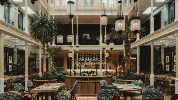A spacious, elegantly designed hotel lobby with high ceilings, ornate columns, and a central bar area. - NoMad London (London)