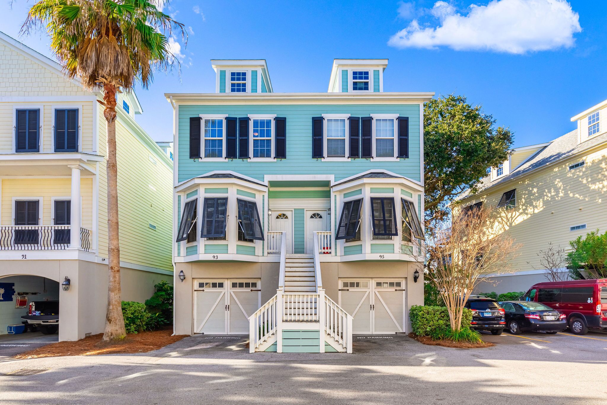 A two-story house with bay windows, a front porch, and a garage.