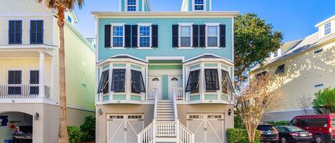 A two-story house with bay windows, a front porch, and a garage.