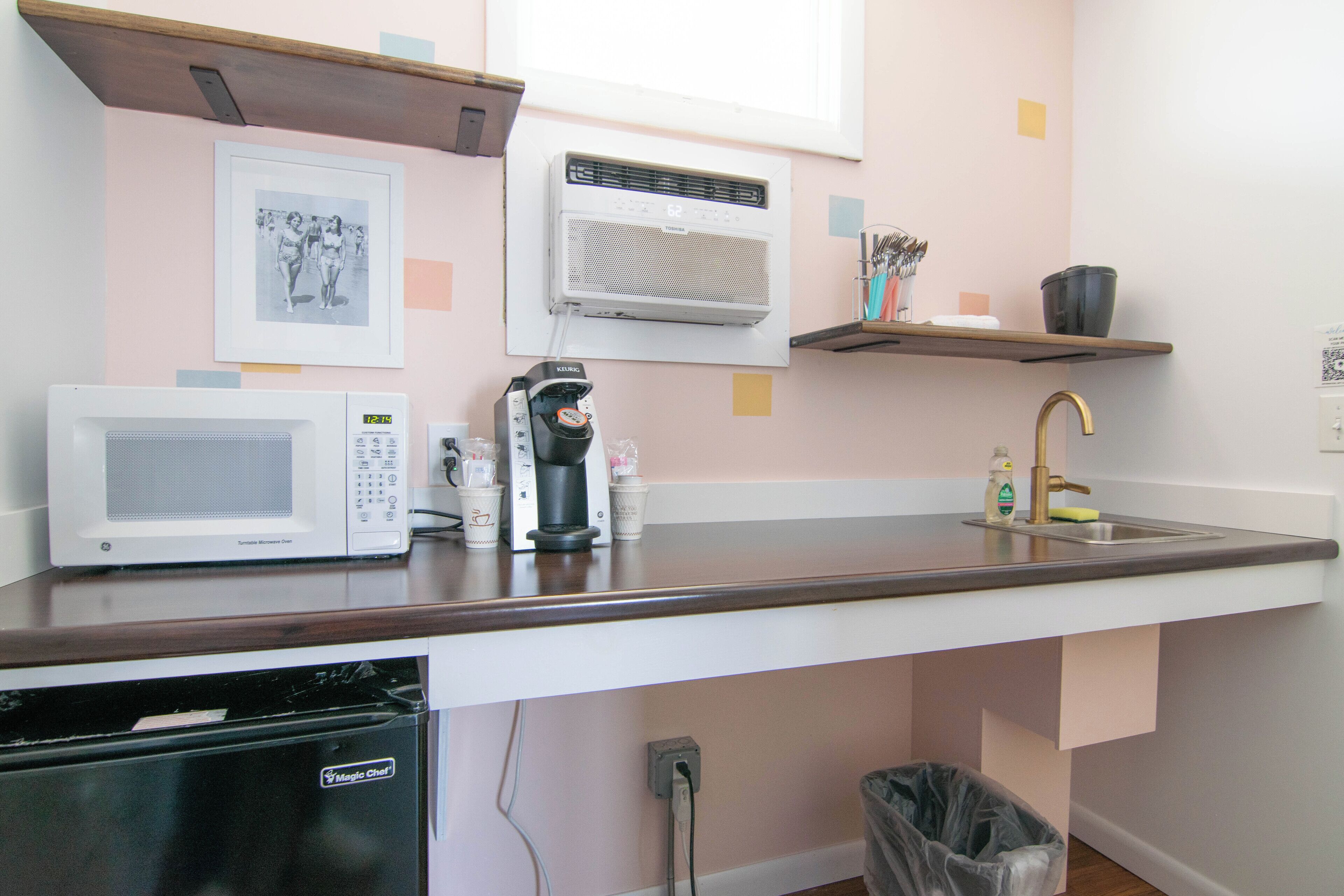 A kitchen with a microwave, coffee maker, and a dishwasher.