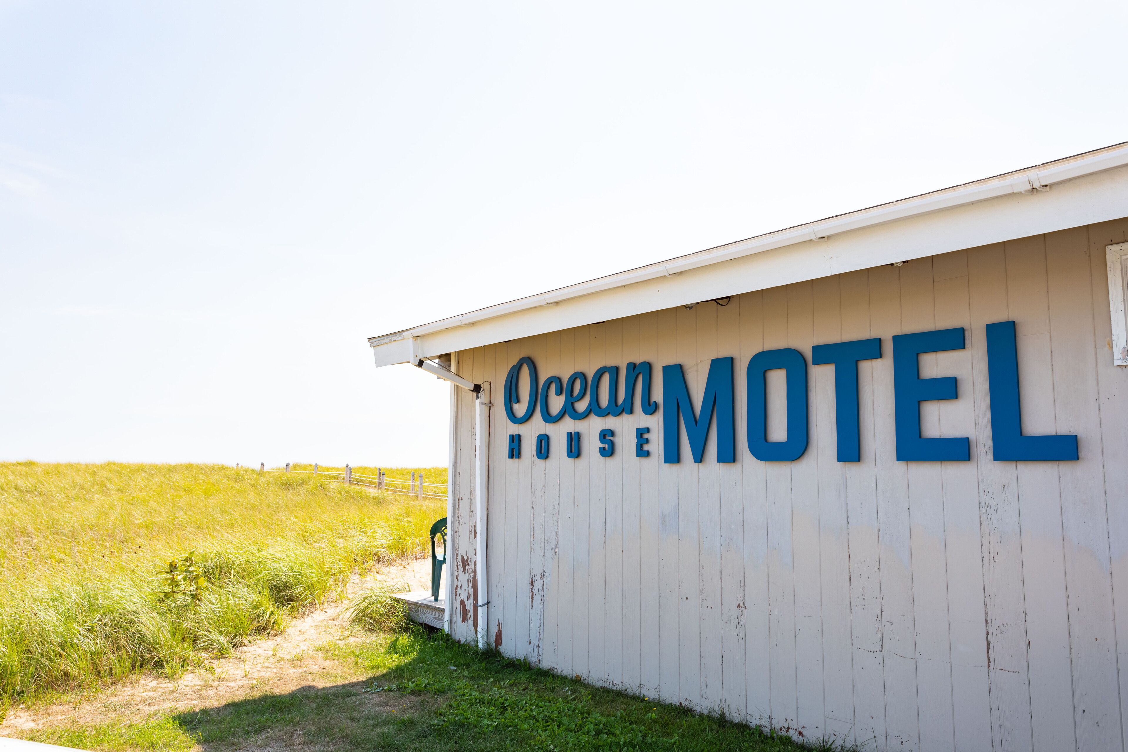 A white building with the sign "Ocean Motel" in blue letters.