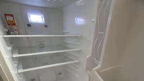 A white refrigerator with multiple shelves and a freezer compartment. - TwinCity 1 BR/1 BA- Minutes to NYC!  (Jersey City)