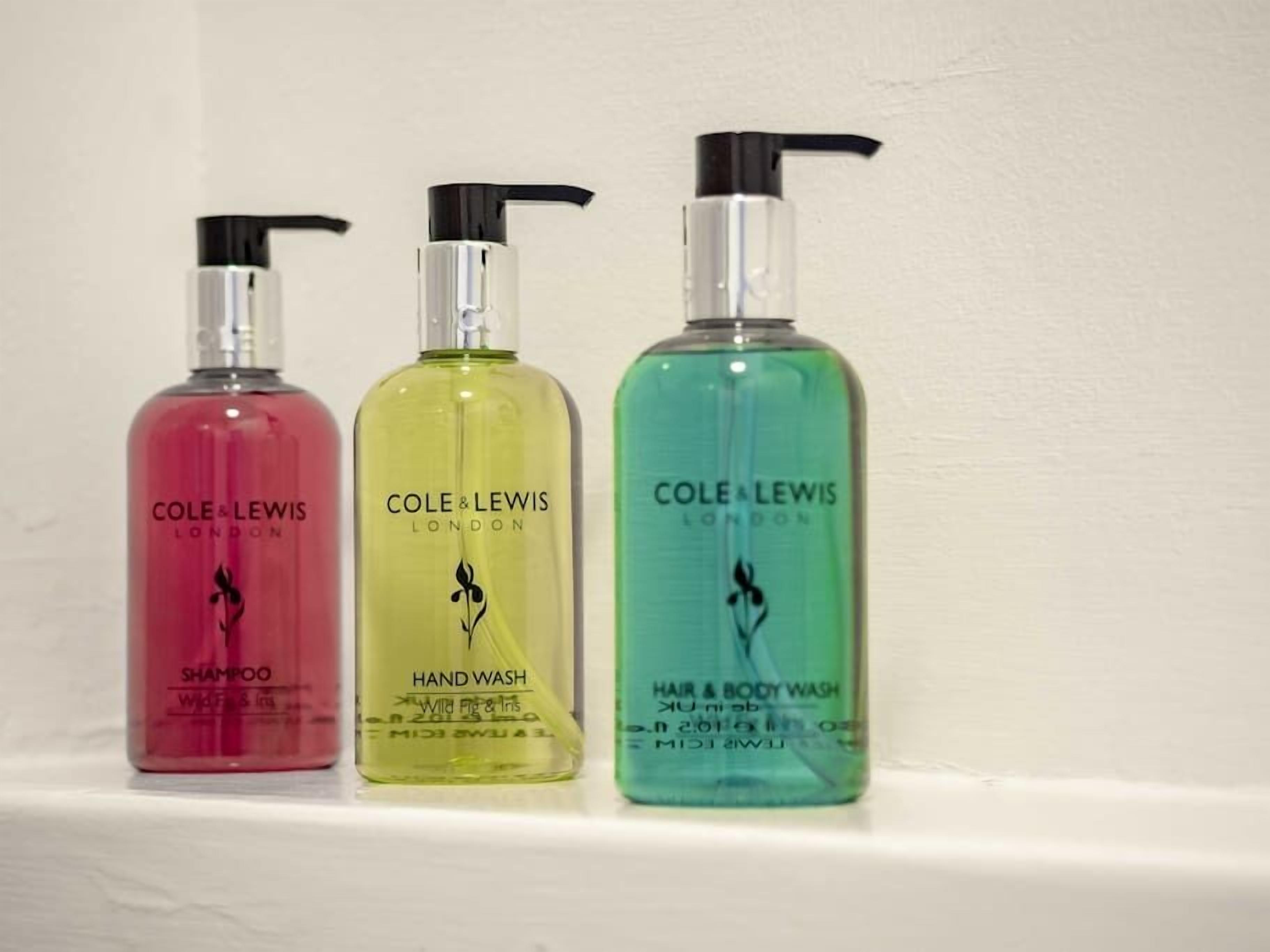 Three bottles of Cole & Lewis products on a shelf.