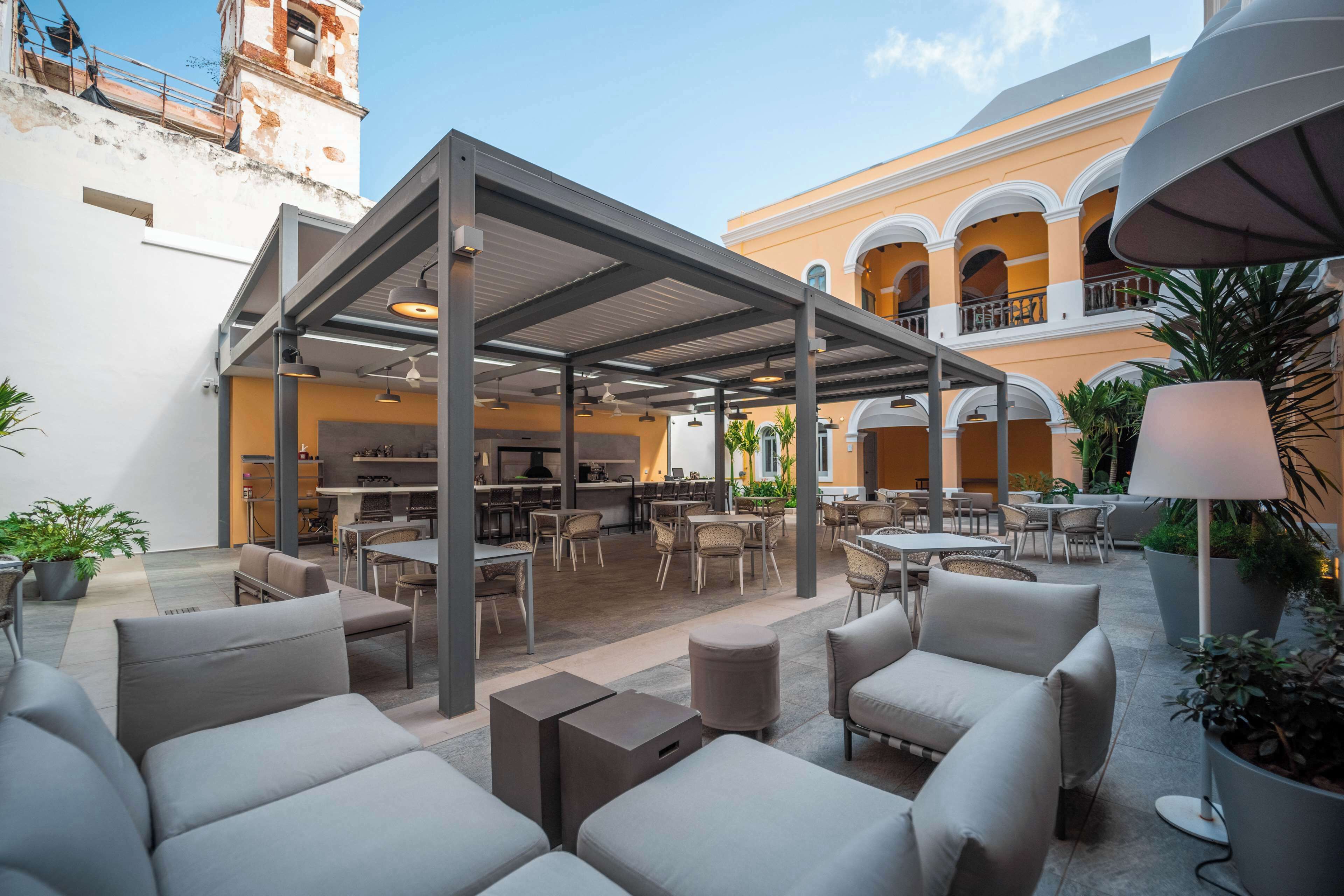An outdoor patio area with seating and a covered dining area.