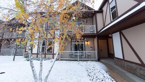 A two-story building with a balcony and a covered porch. - 1 Bedroom Villa at Mountain Run at Boyne Mountain (Boyne Falls)
