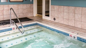 A hot tub with a metal ladder, tiled walls, and a tiled floor. - 1 Bedroom Villa at Mountain Run at Boyne Mountain (Boyne Falls)