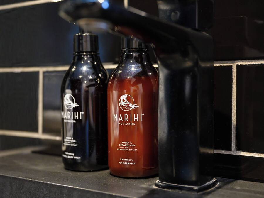 Deux bouteilles de gel douche Marihi sur le comptoir d’une salle de bain.