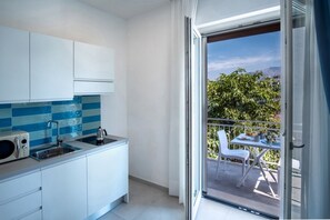 Fridge, microwave, stovetop, coffee/tea maker