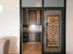 Enjoy cooking in this well-equipped kitchen with an oven and stainless steel range hood.