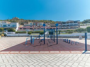 Work out in style with our outdoor fitness area featuring pull-up bars and a climbing structure.