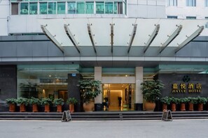 The exterior of Jiayue Hotel with a modern facade, large glass windows, and a welcoming entrance. - Jiayue Hotel (Shenzhen)