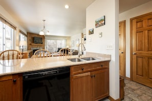 Enjoy cooking in this well-equipped kitchen with a central island, dishwasher, and dining area.