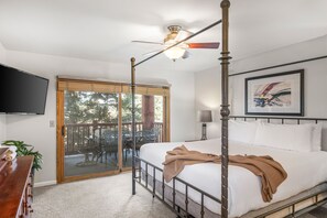 Relax in comfort with a four-poster bed, flat-screen TV, and ceiling fan. Enjoy the view from the outdoor deck with a table and chairs.