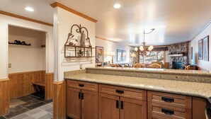 A spacious kitchen with granite countertops, wooden cabinetry, and a stone backsplash. - Managed by Park City Lodging-True Ski-In/Ski-Out to Park City Mountain Resort! (Park City)