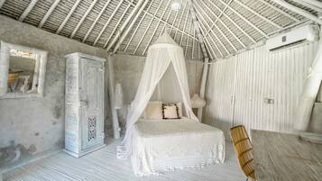 A bedroom with a canopy bed, a wardrobe, a table, and a chair.