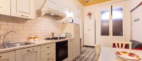 Apartment, 2 Bedrooms | Private kitchen | Full-sized fridge, microwave, stovetop, cookware/dishes/utensils