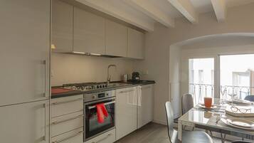 Apartment, 1 Bedroom, Balcony | Private kitchen | Full-size fridge, oven, stovetop, coffee/tea maker