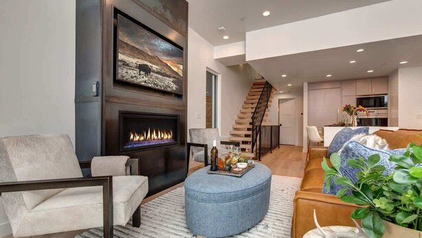 A modern living room with a fireplace, a staircase, and a kitchen area. - Abode on Cloud 9, private hot tub, Old Town retreat, groups (Park City)
