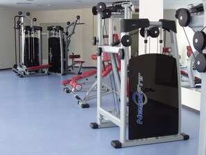 A gym with various exercise machines, benches, and weights. - Kuban Resort and Aquapark (Nessebar)