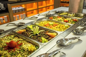 A buffet with various food options and serving utensils. - Kuban Resort and Aquapark (Nessebar)