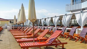 A poolside area with sun loungers and umbrellas. - Kuban Resort and Aquapark (Nessebar)