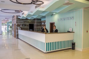 A reception desk with a sign reading 'RECEPTION' and a 'CHANGE' sign above it.
