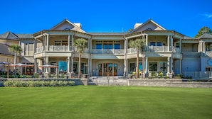 A large, multi-story building with a symmetrical facade, multiple balconies, and a well-maintained lawn in front. - New Inventory! Updated Kitchens and Baths 2 BR Bikes & Beach Gear included (Hilton Head Island)