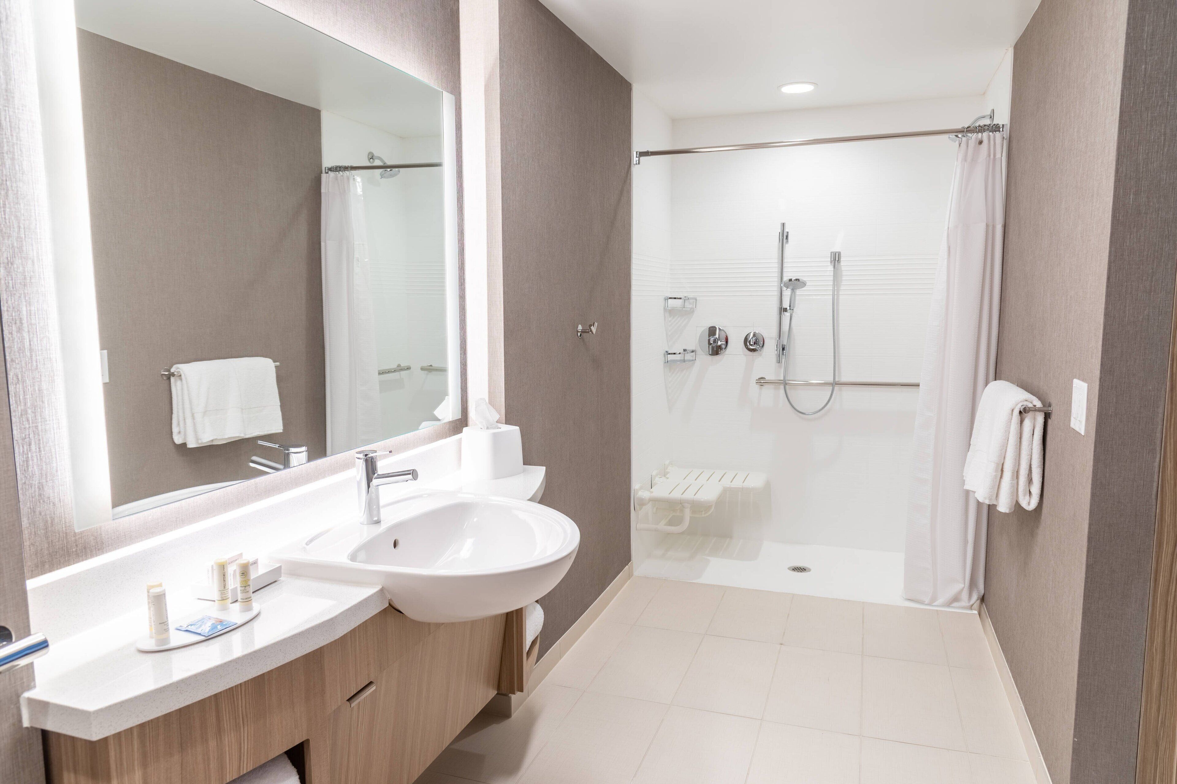 shower, designer toiletries, hair dryer, towels