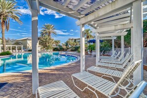 A pool area with lounge chairs, a pool, and a covered patio. - Sandy Toes Gated Community*Pool*Gym*Beach Svc! (Miramar Beach)