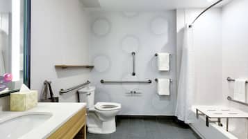 Un baño moderno con inodoro, lavamanos y bañera.