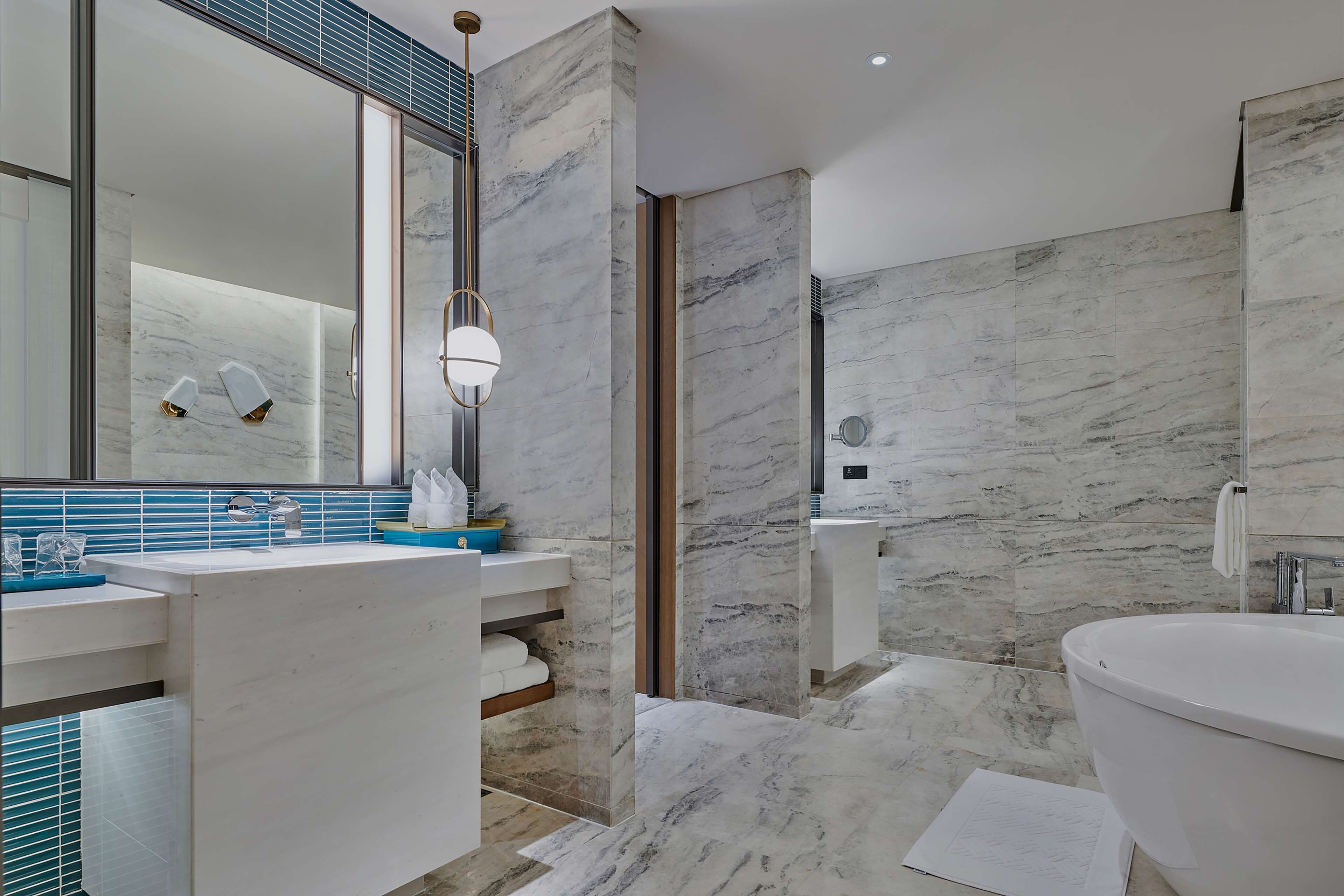 Deluxe Suite, 1 King Bed | Bathroom | Separate tub and shower, rainfall showerhead, designer toiletries