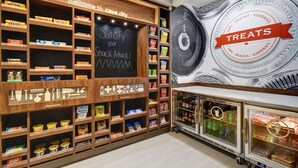 A snack display area with various packaged snacks and a chalkboard sign. - Hampton Inn Cave City, KY (Cave City)