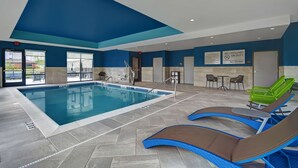 An indoor swimming pool with lounge chairs and a sign indicating no lifeguard on duty. - Hampton Inn Cave City, KY (Cave City)