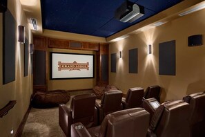 A home theater room with a starry ceiling, a screen displaying "Grand Lodge," and leather recliners. - Ski -in/out Luxury 2 BR at Grand Lodge on Peak 7, Breckenridge, CO (Breckenridge)