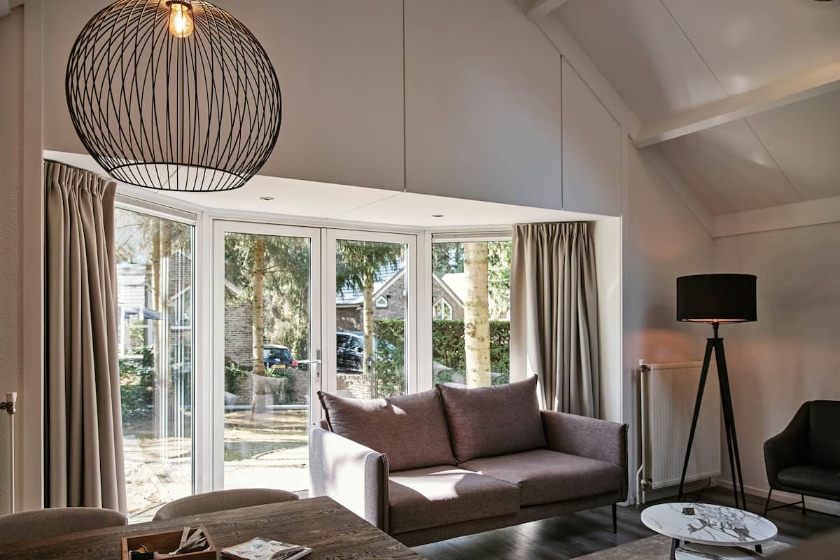 A modern living room with a sofa, a coffee table, and a floor lamp.