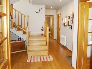 A wooden staircase leading to a second floor, a radiator on the wall, and a small toy figure on the landing. - House 5 rooms 10 Pax, Fireplace, Garden, Cadí Views & Wi-Fi (Prullans)