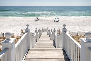 A wooden boardwalk leading to a beach with white railings and a gate. - Beachside in Seaside! Stunning Gulf views from balconies + 2 Adult Bikes! (Santa Rosa Beach)