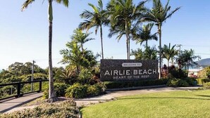 A sign welcoming visitors to Airlie Beach, labeled as the 'Heart of the Reef'. - OCEAN VIEWS 10A pool & Spa Wi-Fi (Airlie Beach)