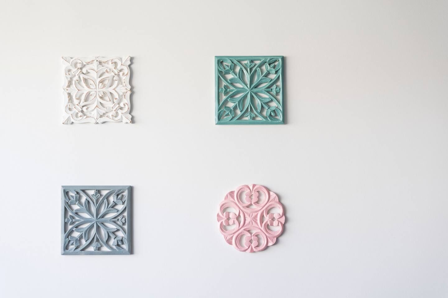 Four decorative wall panels with intricate designs.