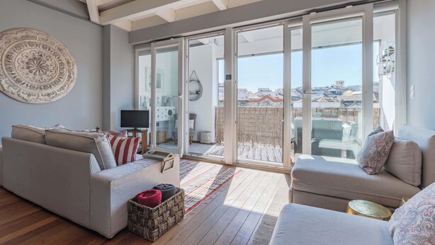 A spacious living area with a large sliding glass door leading to an outdoor balcony. - Oporto LightHouse Apartment by DA'HOME (Porto)