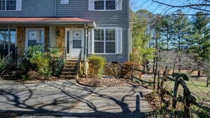A two-story house with a front porch, a stone foundation, and a garage. - Holidays are over!!! Come relax and unwind at Magnificent Views in Murphy!!! (Murphy)